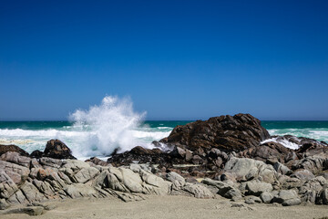 Rocky beach at Tsaarbank in West Coast national Park, Langebaan with waves crashing on the rocks.