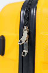 Yellow bright suitcase for tourist trips. High-quality yellow suitcase