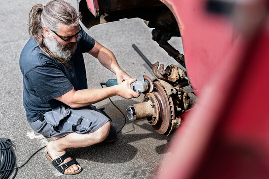 Mature man repairing car