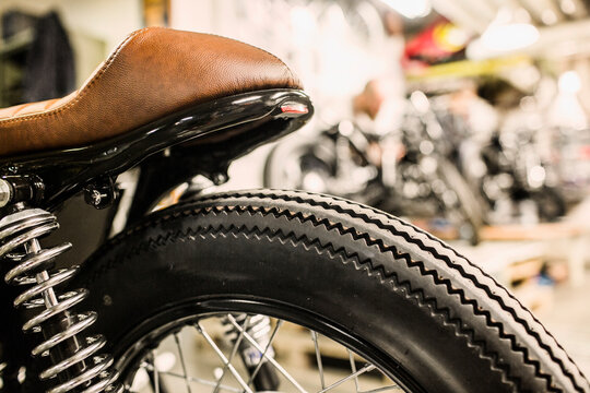 Close up of retro motorcycle wheel and leather seat