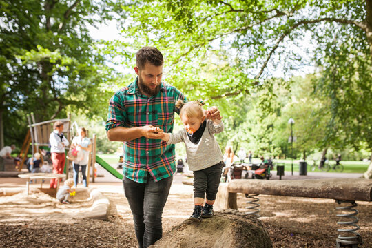 Father with daughter (2-3) in playground