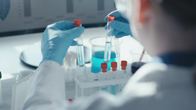 Laboratory experiment in the field of cosmetology, aimed at creating effective products for skin care and facial rejuvenation. Scientist in medical test tube laboratory.