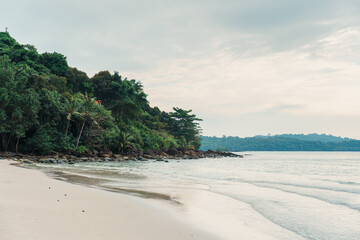 Tropical sea with the beach and the forest in gloomy day