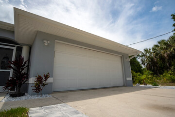 Wide garage double door and concrete driveway of new modern american house