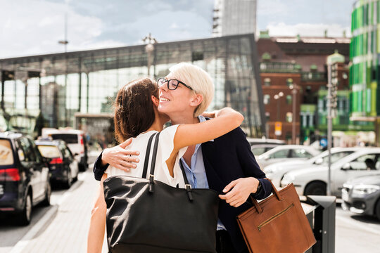 Two women embracing in parking lot
