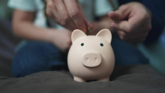 family saving coins in a piggy bank. happy family business concept. father and daughter save coins in a piggy bank. investment business concept. saving money teach happy family father and daughter