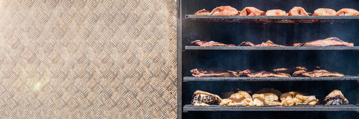 Hot smoked sturgeon. A whole hot-smoked sturgeon lies in the smoking shop. The process of smoking...