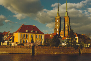 Fototapeta na wymiar Poland, Wroclaw, April 16, 2022. View to Odra River and Tumski Island. Old Town of Wroclaw in Spring 