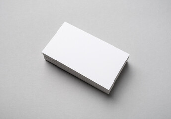Stack of blank business cards on gray paper background. Branding mock up. - obrazy, fototapety, plakaty