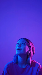 Impressed girl portrait. Amazed promotion. Neon color light startled woman looking up saying wow...