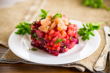 vinaigrette salad of boiled vegetables with salted fish in a plate