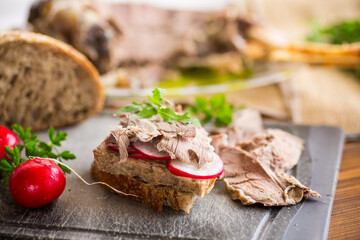 sandwich with baked meat, radish and herbs