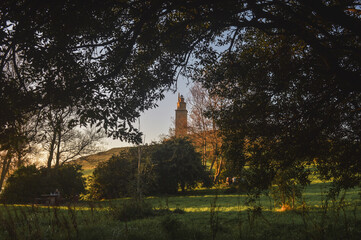 tower of hercules seen from the forest 
