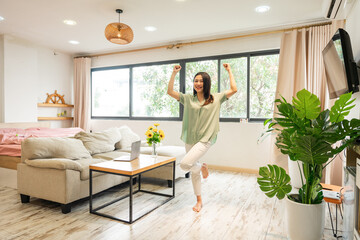 portrait of asian girl standing in her apartment