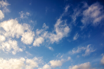 Clouds in bright blue sky background or texture