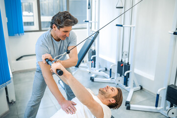 Physical therpaist working with the patient in a rehabilitation center