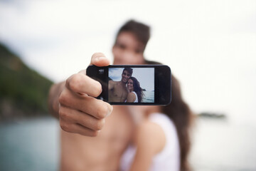 Memories in the digital age. an affectionate young couple taking a self portrait while enjoying a boat ride.