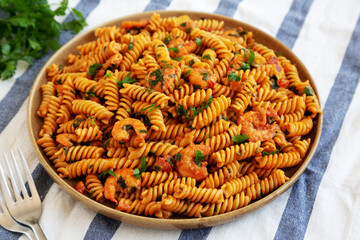Homemade Creamy Tomato Shrimp Rotini Pasta with Parsley on a Plate, side view.