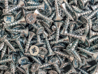Lots of galvanized self-tapping screws as a background