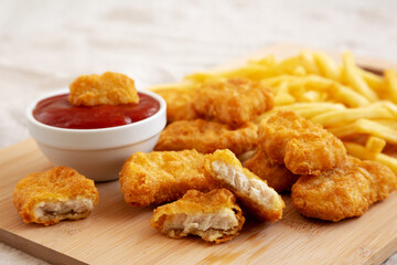 Chicken Nuggets and French Fries with Ketchup Ready to Eat, side view.