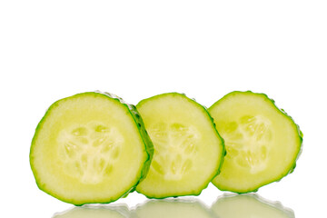 Three slices of ripe gherkin cucumber, macro, isolated on white background.