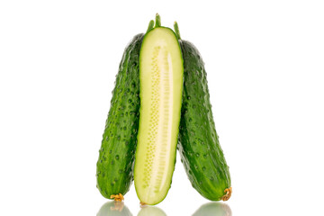 One half and two whole ripe gherkin cucumbers, macro, isolated on white background.