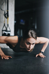 Fototapeta na wymiar Fit is a lifestyle choice. an attractive young woman doing push ups in a gym.