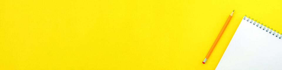 Banner. White notebook with a spring and a pencil.