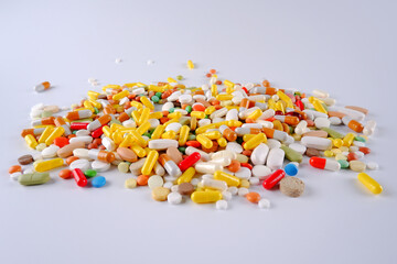 A bunch of colorful pills, capsules, tablets in a shell on a white background. Production and disposal of medicines.Pharmaceutical preparations.Sale of medicines.Vitamins for a healthy lifestyle.