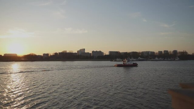 A tugboat glides along the Scheldt river in Antwerp Belgium