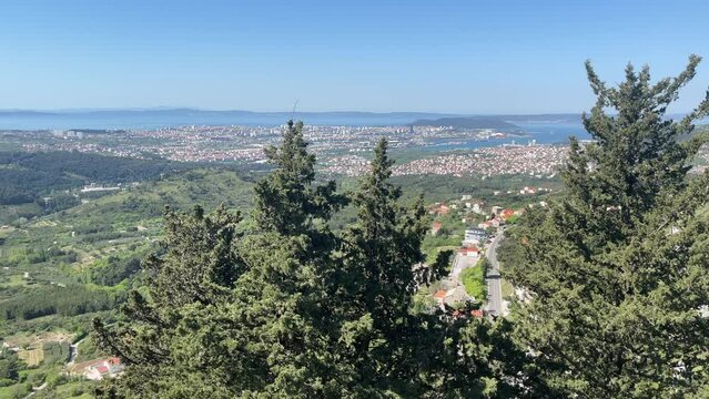 4K aerial video from Klis Fortress overlooking Split, Croatia, with sweeping views of the surrounding mountains, the Adriatic Sea, and the historic Dalmatian coastline. The medieval fortress provides 