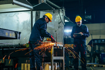 Metal worker with boss in workshop.