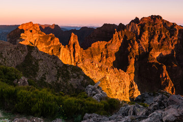 Sunrise in Madeira mountains peaks in sunlight, scenic view over landscape and Pico Ruivo, Portugal