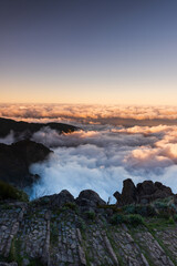 Madeira mountains landscape with peaks above clouds at sunset