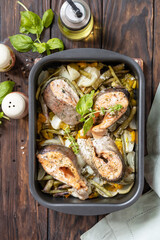 Healthy baked fish salmon steaks with basil, green beans and sweet peppers on a rustic table. Low carb dinner, healthy nutrition concept, diet menu. View from above.