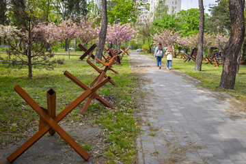 «Kyiv, Kyiv region Ukraine 05.04.2023: «The city's defense line runs through a park with cherry...