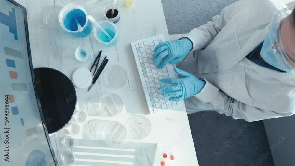 Aufkleber Analysis of scientific research data in the laboratory in order to identify new trends and predict future results. A scientist sits at a monitor and types on a keyboard. Medical worker at the table.
