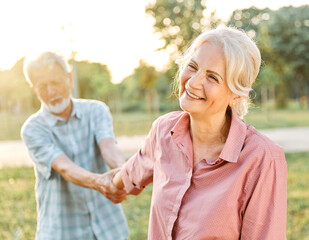 woman man senior couple happy retirement together elderly active vitality park fun smiling love old nature wife happiness mature walking holding hands