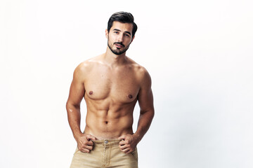 Fototapeta premium Male athlete model with naked torso and packs of abs sporty on white isolated background, trendy clothing style, copy space, space for text