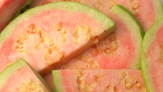 Rotational 360 degree video of guava fruit. Pink guava closeup video.