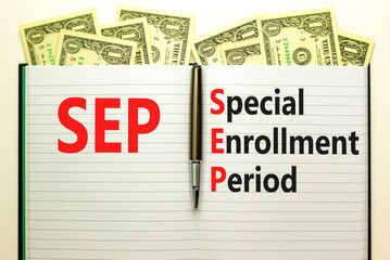SEP symbol. Concept words SEP Special enrollment period on beautiful white note. Dollar bills....