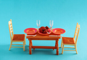 Plastic doll furniture on a blue background.