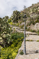 Stone path uphill with cactuses above Taormina town in Sicily