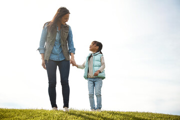 Fototapeta premium You are the best adventure. a woman holding her little girls hand as they walk outdoors.