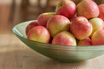 An apple per day keeps the doctor away. Glass bowl with lots of healthy apples - a really healthy and tempting treat.