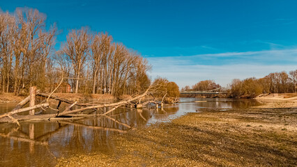 Winter landscape with reflections and two bridges on a sunny day near Landau, Isar, Bavaria, Germany