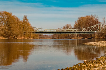 Winter landscape with reflections and two bridges on a sunny day near Landau, Isar, Bavaria, Germany