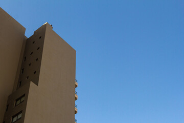 Modern building facade against the blue sky