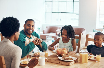 Start the day with family, laughter and food. a family having breakfast together at home.