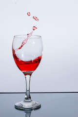 Splashes of red wine in a glass